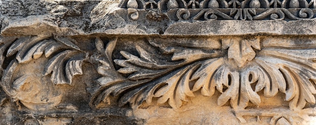 Ancient weathered stone-cut relief on the ruins of a building in the ancient city of Myra, Turkey