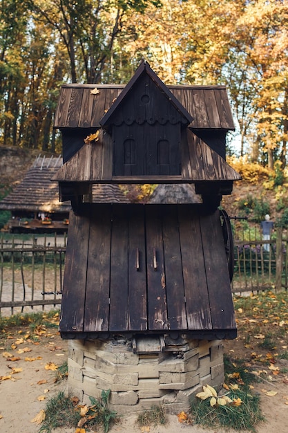 Foto antico pozzo a forma di vecchia casa in legno.