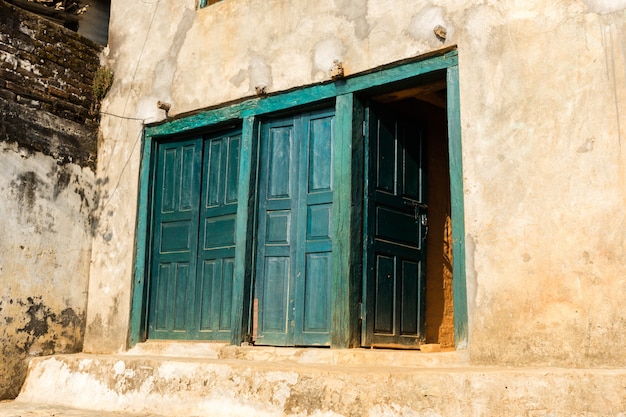 Ancient wooden door in old stone wall