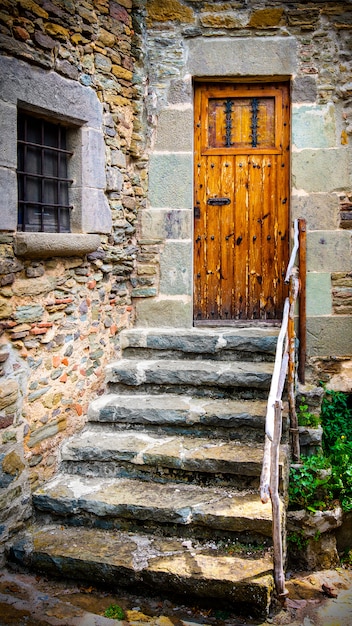 The ancient wooden door and stone staircase