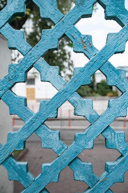 Ancient wooden gate grid with a crumpled blue color