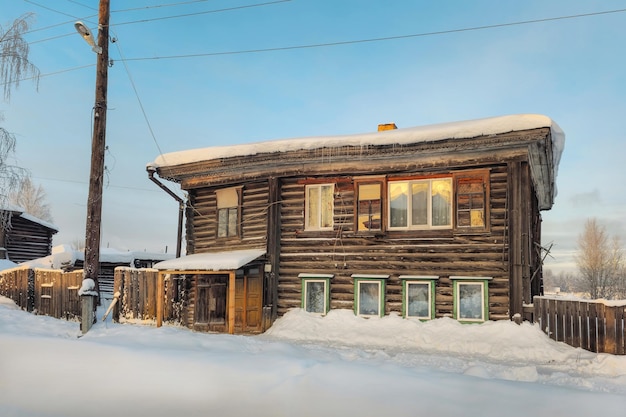 Ancient wooden hut under the snow Rural life and way of life pr