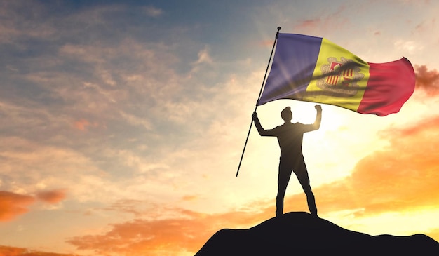 Andorra flag being waved by a man celebrating success at the top of a mountain 3D Rendering