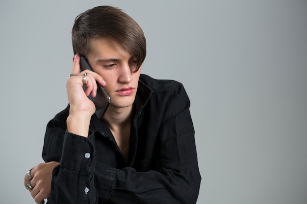 Androgynous man talking on his mobile phone