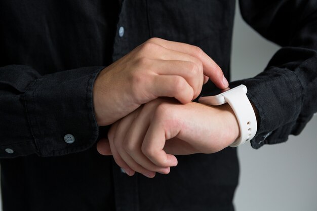 Androgynous man using smart watch