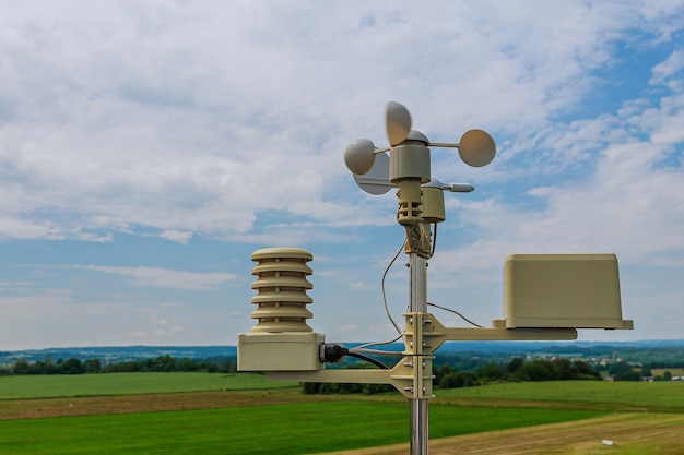 Anemometer, wind speed measurement, small weather station. Anemometer on blue sky.