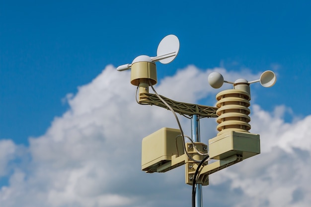 Anemometer, wind speed measurement, small weather station. Anemometer on blue sky.