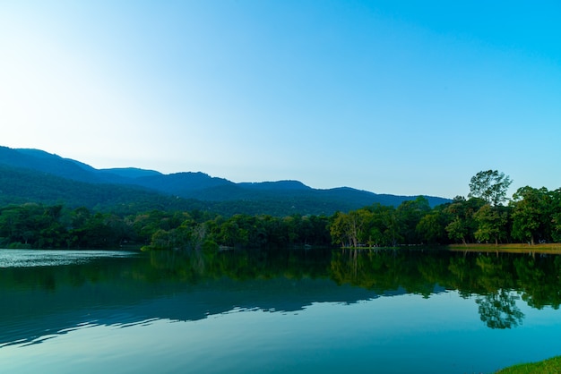 Ang Kaew-meer aan de Universiteit van Chiang Mai met beboste berg en schemeringhemel