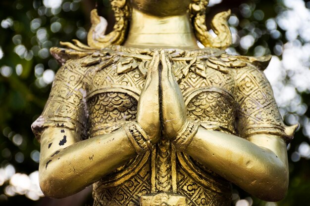 Angel brass statue in garden of Phra That Nadoon Chedi or Na Dun Pagoda for thai people travel visited and respect praying at Mahasarakham city on January 11 2019 in Maha Sarakham Thailand