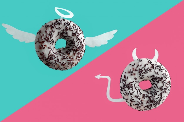 Angel and devil donuts on a blue and pink background