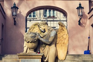 Photo angel statue in front of gate on malostransky cemetery prague