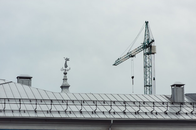 An angel statue with an arrow on the roof.