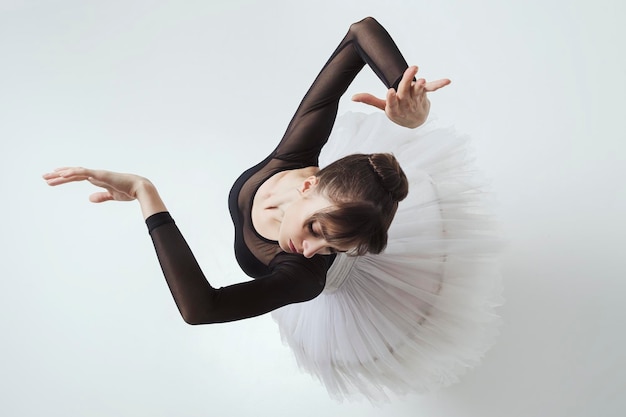 Angle from above on a ballerina up to the waist with her hands showing a dance