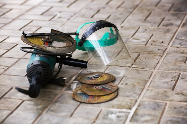 Angle grinder and discs, face shield mask. Working environment, real conditions. High quality photo