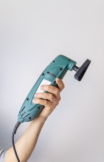 Angle grinder in the hands of a man isolate. Selective focus. 