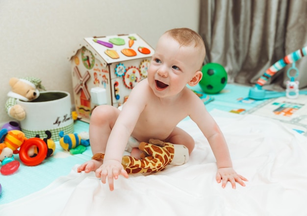 Above angle shot of adorable Baby boy lying on child friendly floor puzzle mats looking up