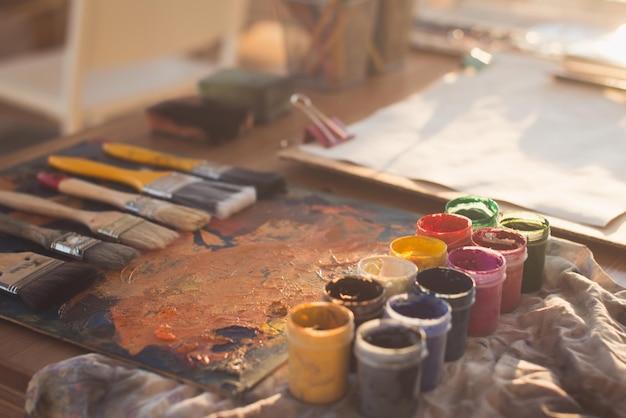 Angle view picture of an old palette with oil paints and gouache set Clean painter workplace ready for drawing