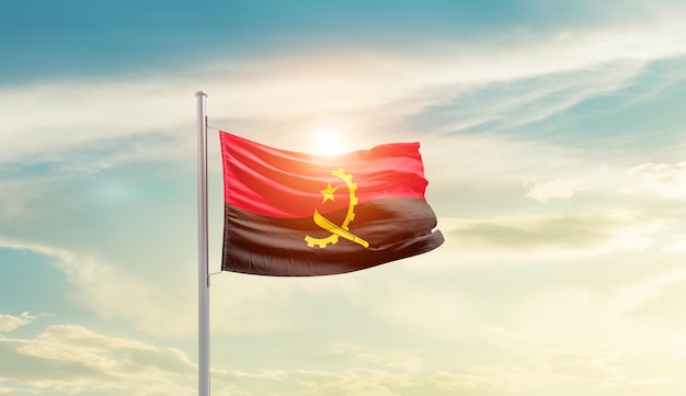 angola national flag waving in beautiful sky.