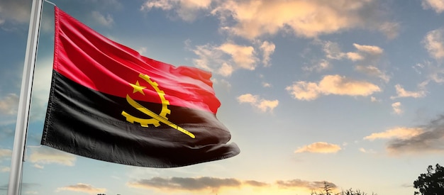 angola national flag waving in beautiful sky.