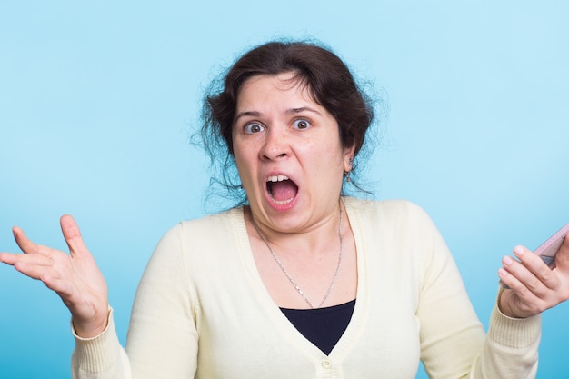 Angry adult woman in a casual blouse