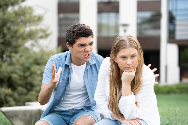 Angry and aggressive hispanic boy shouting girlfriend