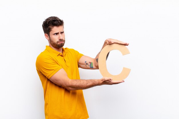 angry, anger, disagreement, holding the letter C of the alphabet to form a word or a sentence.