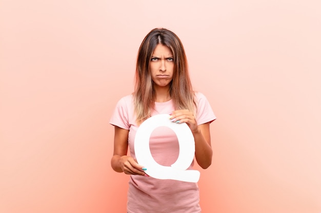 angry, anger, disagreement, holding the letter Q of the alphabet to form a word or a sentence.