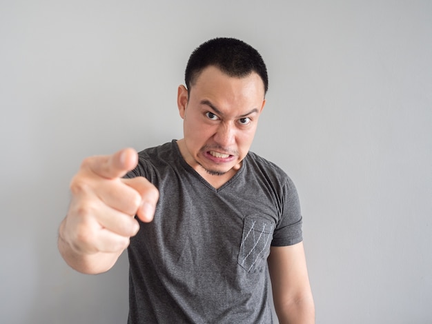 Angry asian man portrait with funny mad face.