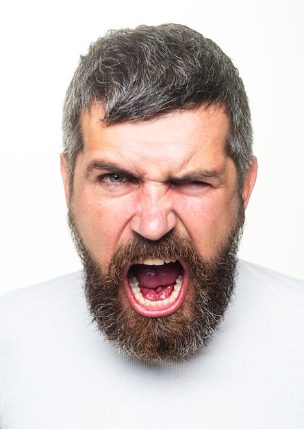 Angry Barber with long beard and moustache in barbershop. Bearded annoyed angry man. Scream stressful face expression.