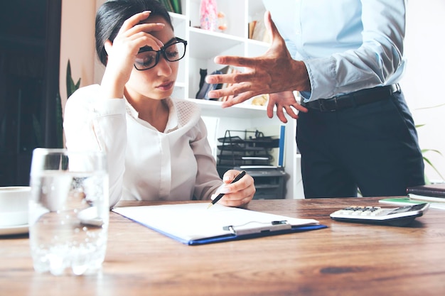 Angry  boss  shouting at his secretary