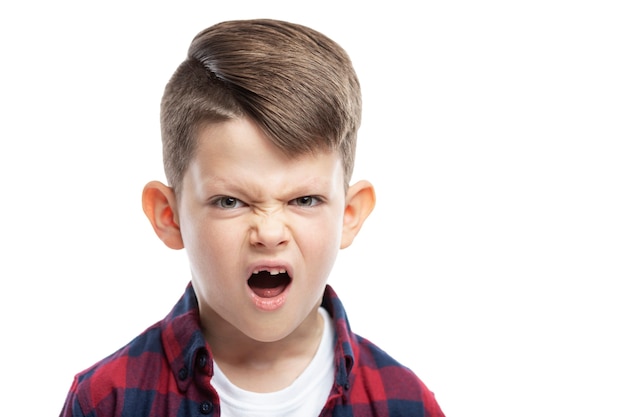 Photo angry boy of 7 years without a front tooth. close-up. isolated on white wall.