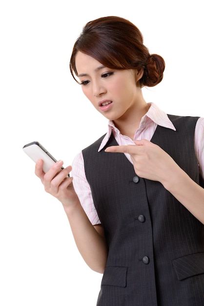 Angry business woman looking message on mobile phone, closeup portrait on white wall.