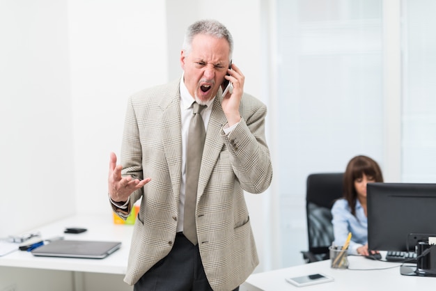 Angry businessman yelling on the phone