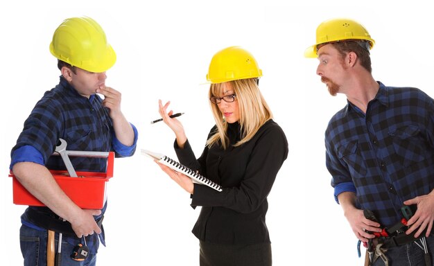 Angry businesswoman and construction workers