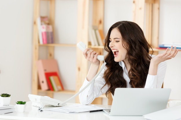 Angry businesswoman shouting on the phone