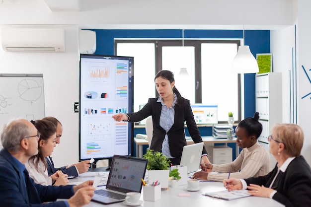 Angry company ceo having a dispute with multiethnic employees during briefing in meeting room