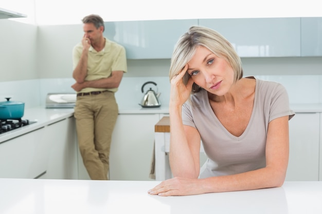 Angry couple after a fight in kitchen