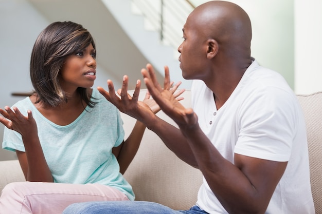 Angry couple having a dispute on sofa