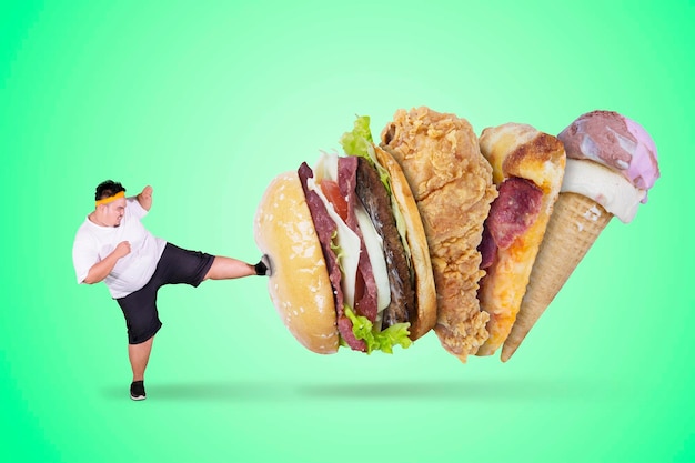 angry fat man kicking fast foods