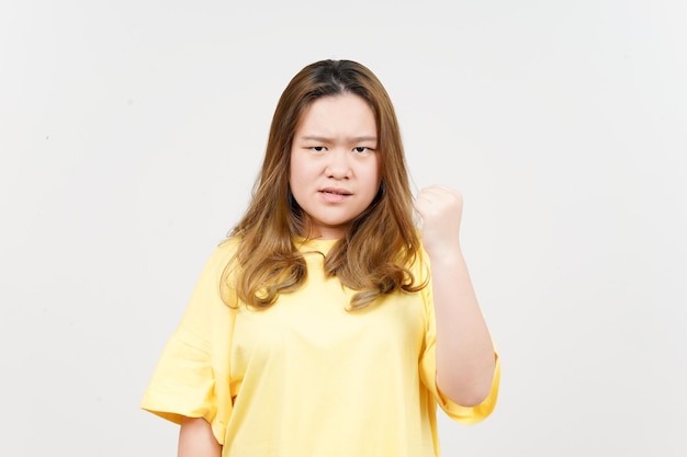 Angry gesture of Beautiful Asian Woman wearing yellow TShirt Isolated On White Background