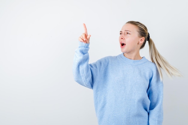 Photo angry  girl is showing her finger on white background