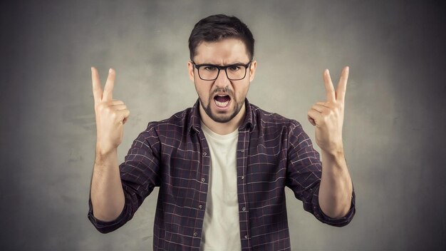 Photo angry guy making an obscene gesture