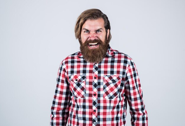 Photo angry handsome bearded guy with unshaven face and stylish hairdo wear casual clothes anger