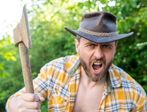 Angry lumberjack with axe in selective focus angry lumberjack with axe outdoor photo of angry lumberjack with axe angry lumberjack with axe
