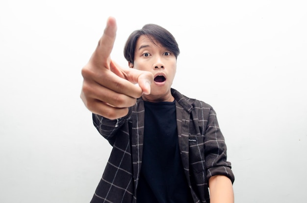 Angry, mad, frustrated asian male millenial worker or student\
in black tshirt pointing to camera