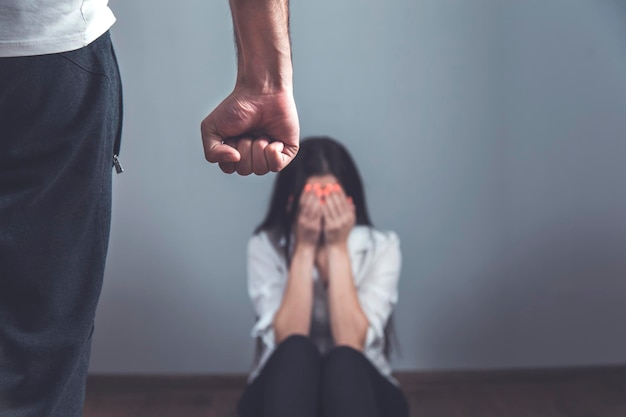 angry man beat sad woman