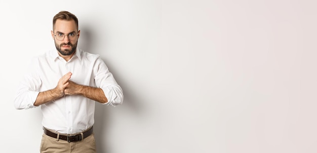 Angry man crack knuckles want to punch someone standing mad against white background