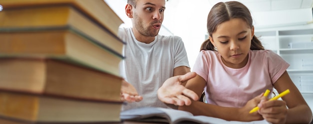 The angry man and a girl doing homework at the desk