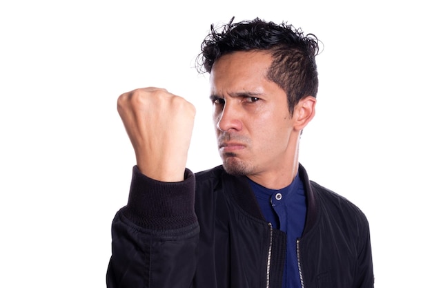 Angry man with desire to punch with fist Young adult showing and clenching his fist to camera