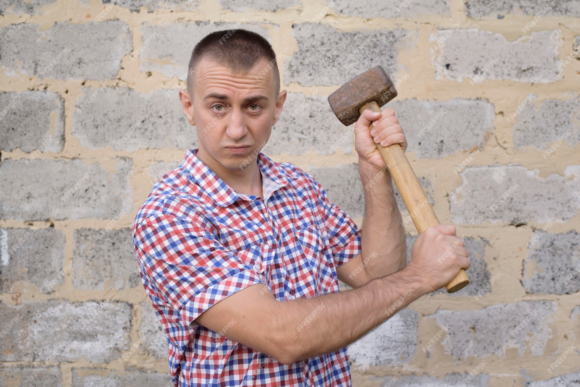 Man hitting wall with sledgehammer hi-res stock photography and